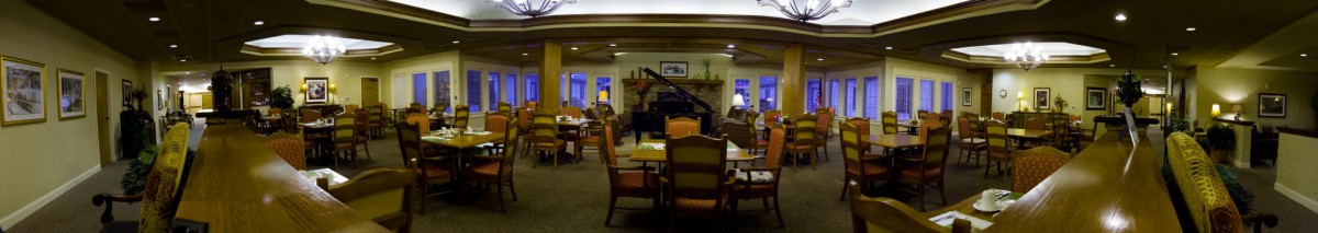 A cozy dining area with a grand piano and comfortable seating.