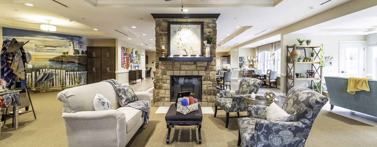 A cozy living room featuring a stone fireplace and comfortable seating.