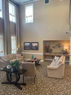A spacious living room with elegant furniture and modern decor.