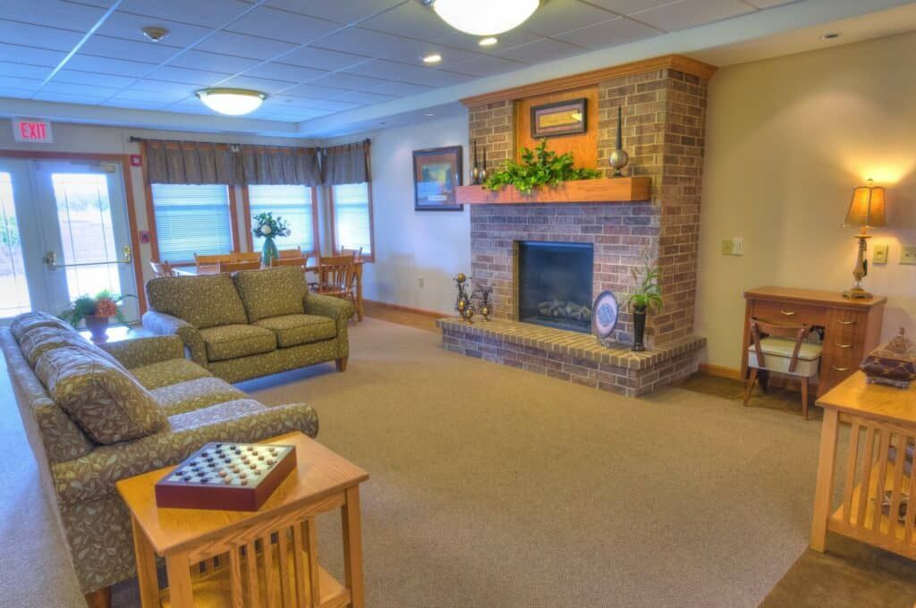 A cozy living room with a fireplace and comfortable seating arrangement.