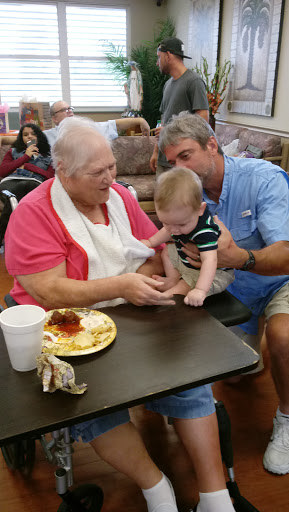 A heartwarming moment shared between a grandmother and her baby as they enjoy time together during a meal.