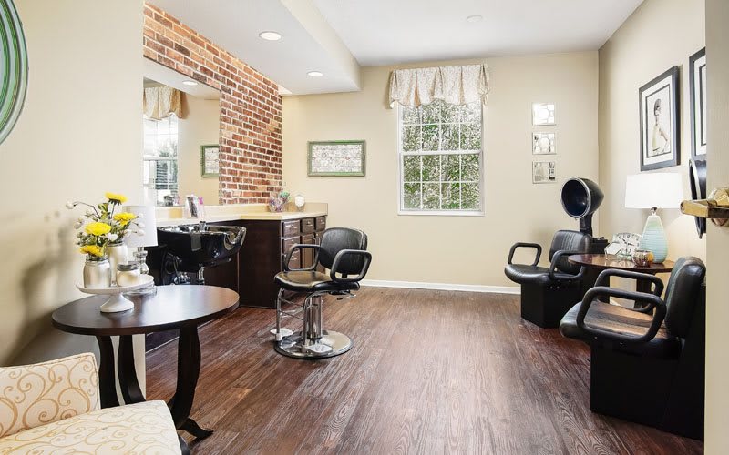A modern hair salon with brick accents and stylish furnishings.
