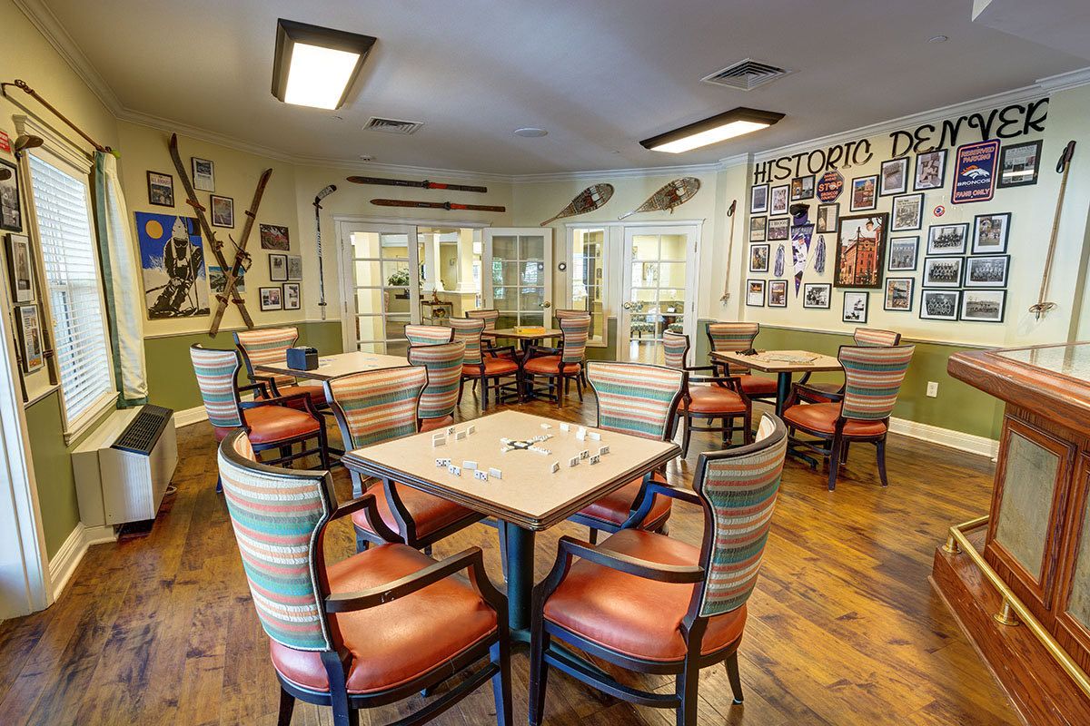 A cozy game room with colorful chairs and decorated walls.