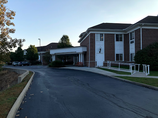 A view of a hotel from the approach road during early morning hours.