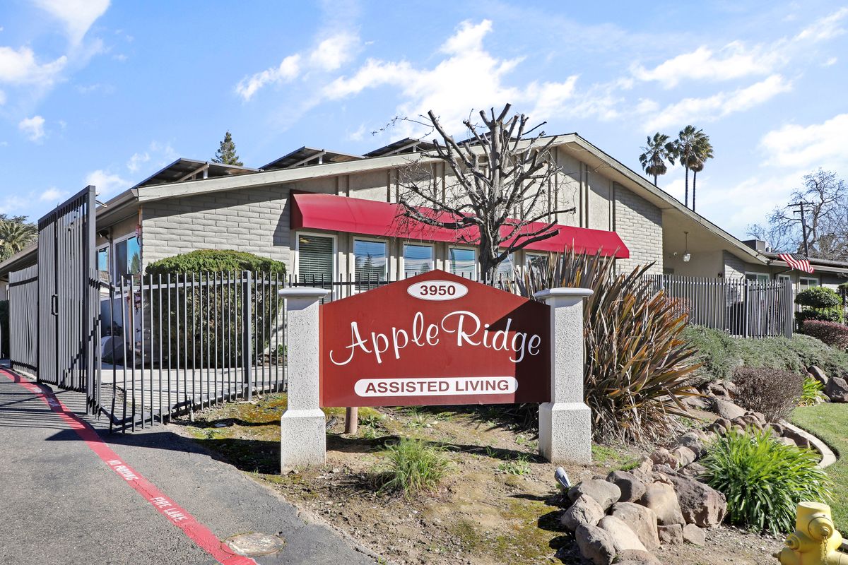 Entrance sign for Apple Ridge Apartments in front of the residential building.