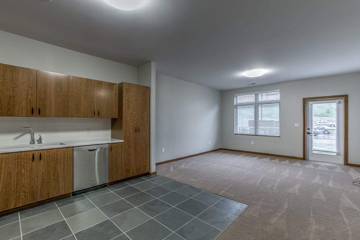 Modern unfurnished apartment with a kitchen and living area.