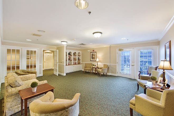 A cozy, brightly lit living room with comfortable seating and tasteful decor.