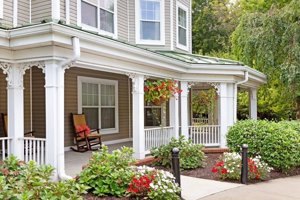A charming house with a welcoming porch and vibrant garden.