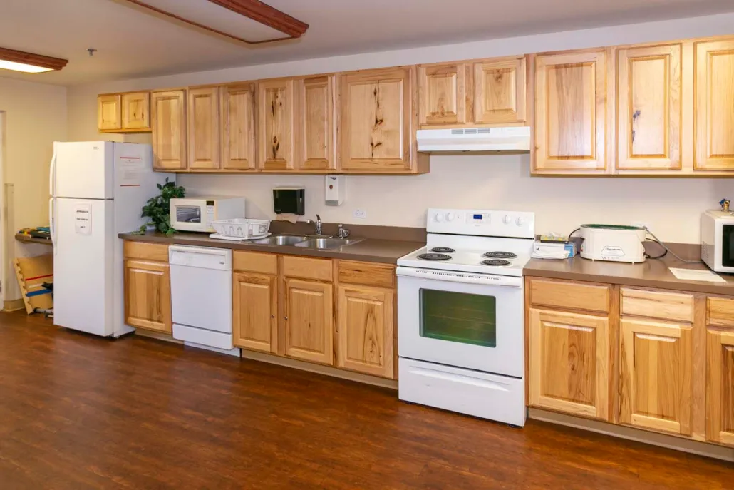 A spacious kitchen with wooden cabinets and modern appliances.