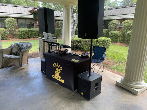 A DJ setup featuring speakers and mixing equipment, perfect for an outdoor gathering.