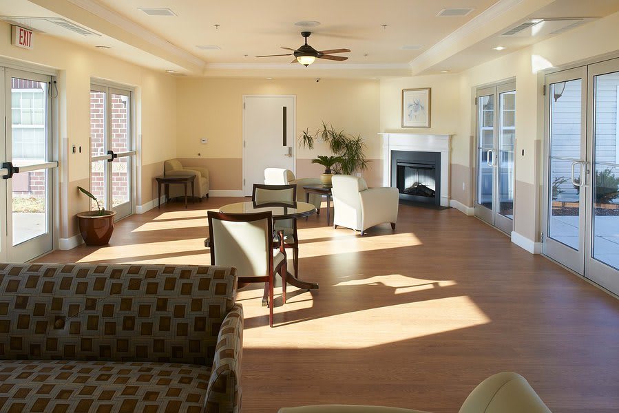 A cozy living room with comfortable seating, a fireplace, and abundant natural light.