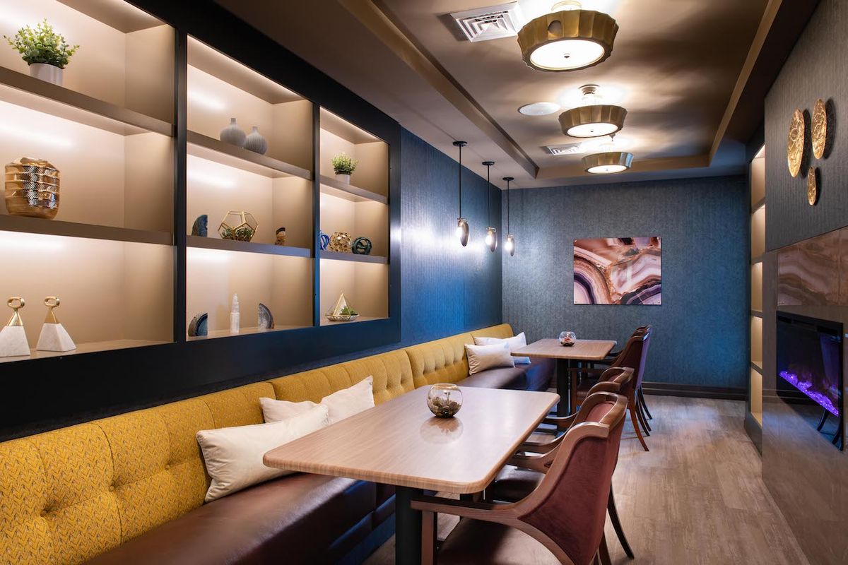 A cozy and modern dining area with stylish furniture and decorative lighting.