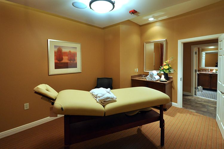 A tranquil spa room with a comfortable treatment table and soothing ambiance.