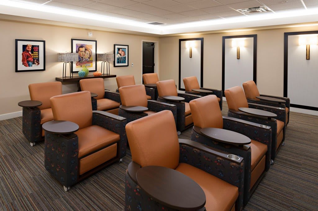 A comfortable lounge area with multiple chairs and ambient lighting.