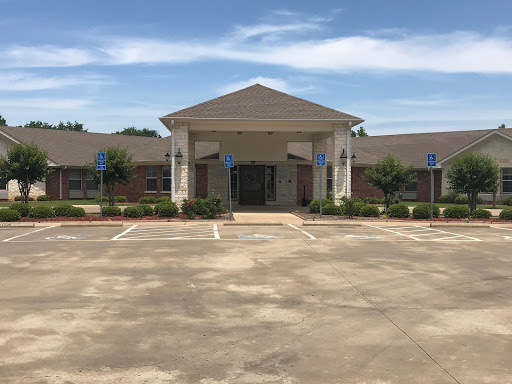 A modern building with a welcoming front entrance and accessible parking.