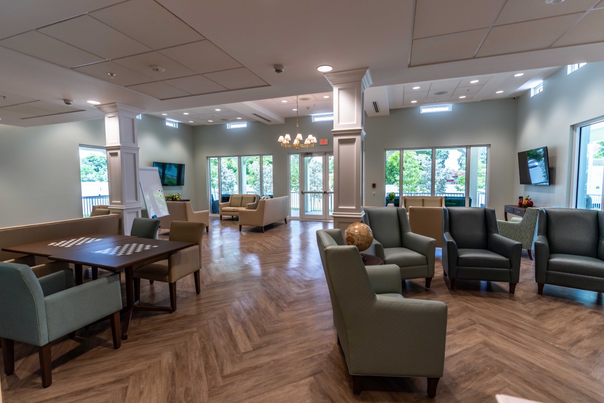 A modern and spacious lounge area with comfortable seating, natural lighting, and elegant interior design.