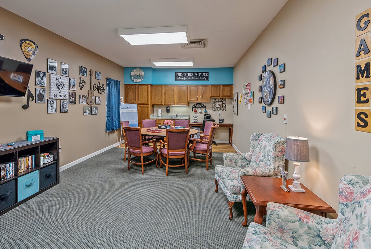 A cozy living space with a dining table, kitchen area, and comfortable seating.
