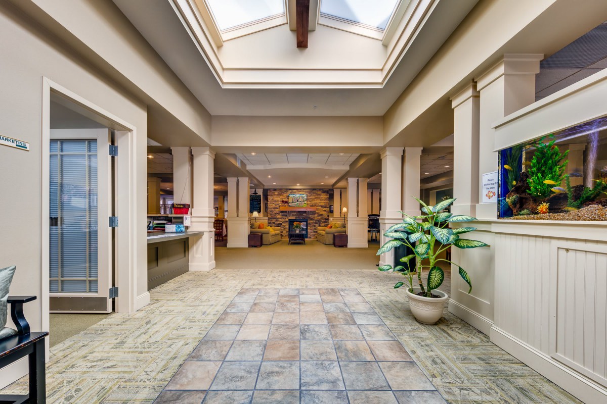 Spacious hallway with skylight and decorative columns.