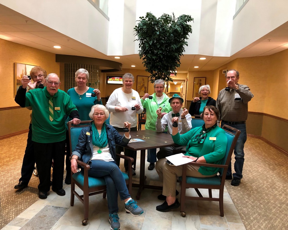 A group of seniors gathered indoors for a casual celebration.