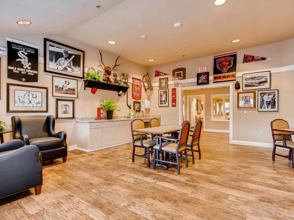 A cozy living room decorated with various framed artworks and comfortable seating.