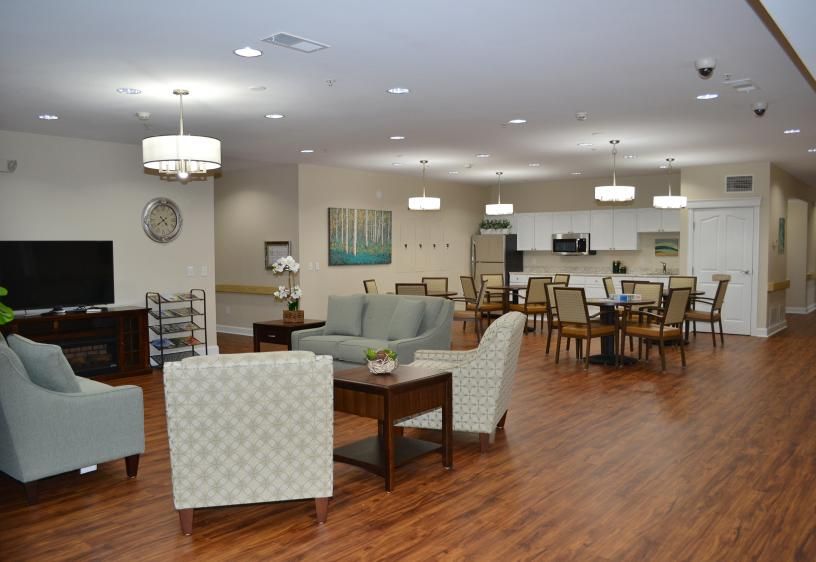 A modern, spacious living and dining area with comfortable seating and elegant lighting.