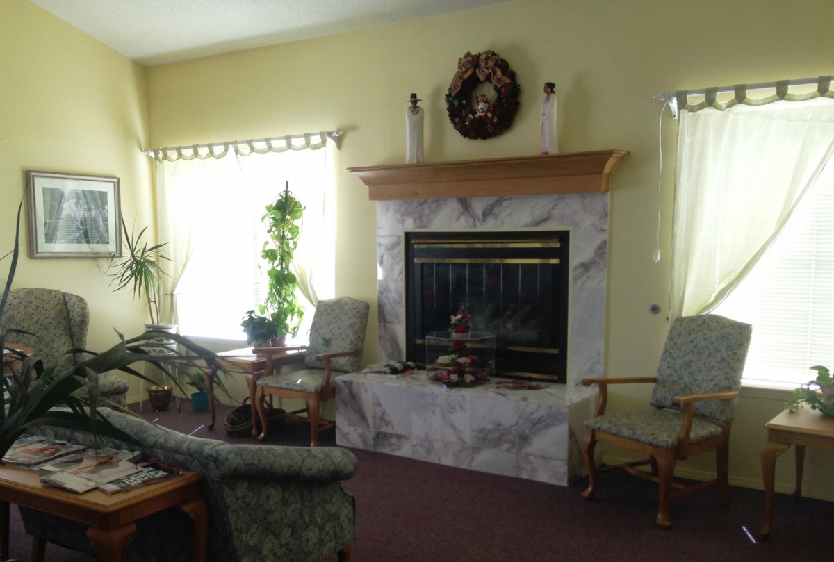 A cozy living room with a fireplace and comfortable seating.