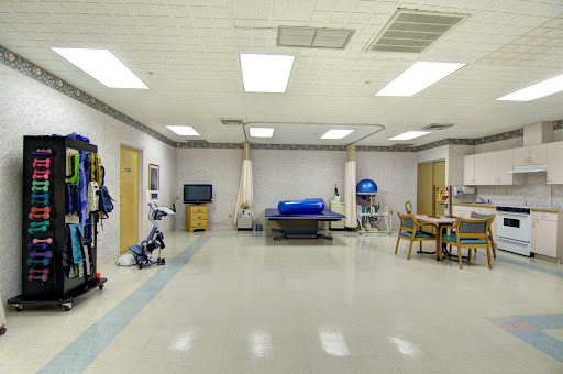 A spacious rehabilitation room equipped for patient care in a medical facility.