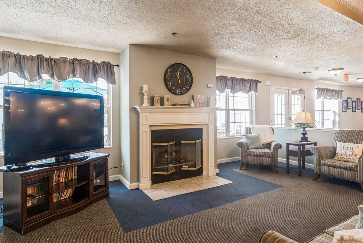 Cozy living room with a fireplace, television, and comfortable seating.