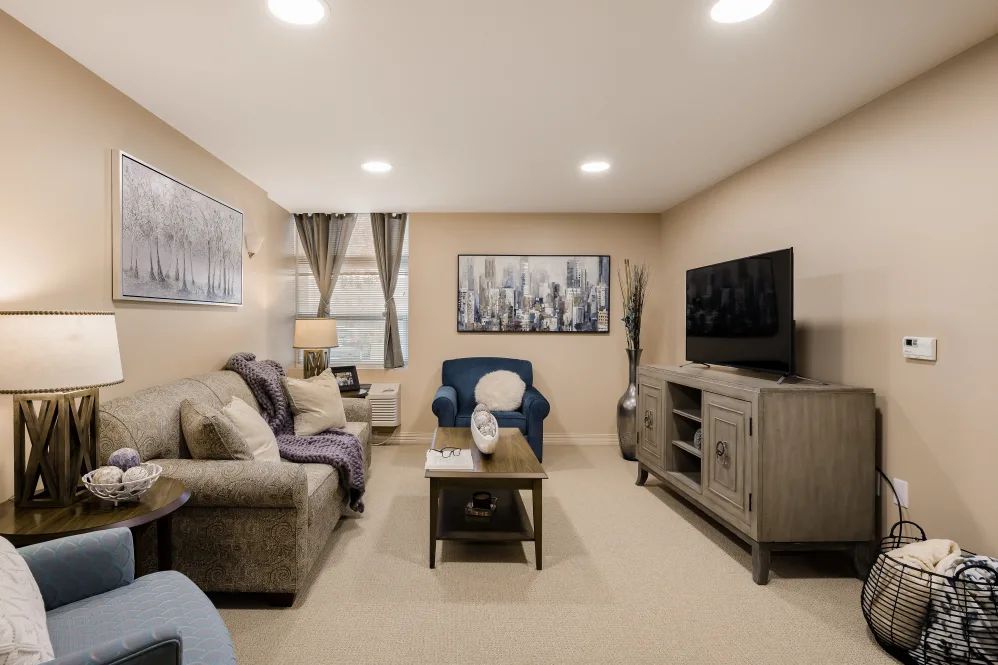 A cozy living room featuring comfortable seating, a television, and tasteful decor.