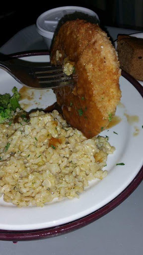 A delicious plate featuring a breaded item alongside fluffy rice and steamed broccoli.