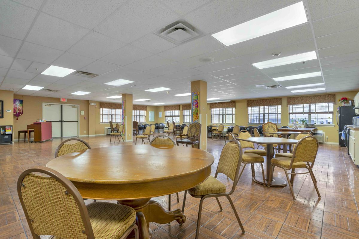 An empty dining area with round tables and chairs.