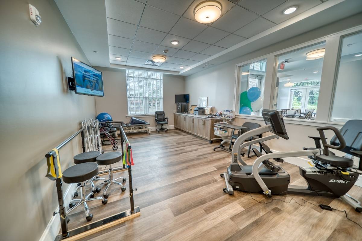 A modern physical therapy and rehabilitation room with various exercise equipment.
