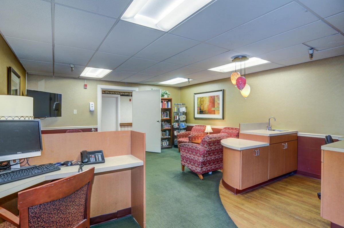An inviting office reception area with comfortable seating and warm lighting.