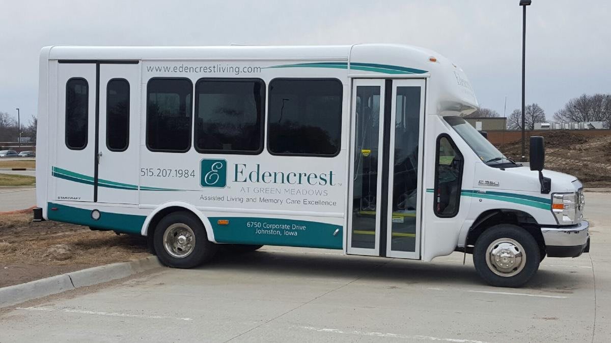 A branded minibus parked on the roadside.
