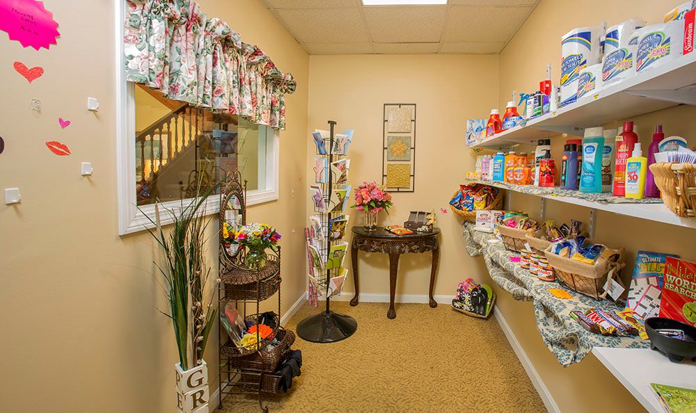 A small store interior with shelves filled with various products and snacks.