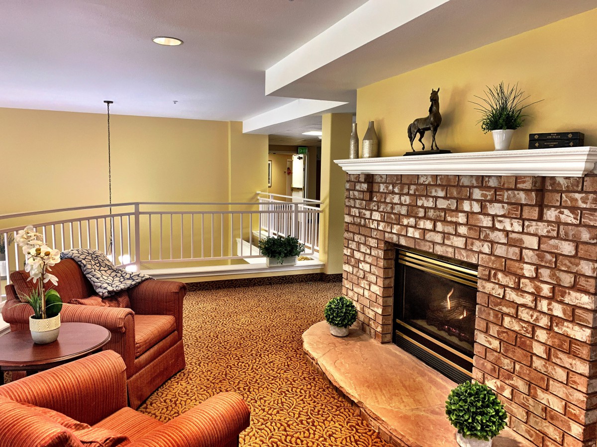 A cozy living room featuring a brick fireplace and comfortable seating.