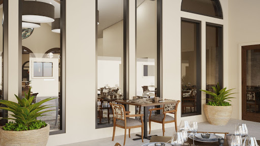 A stylish dining area featuring modern furniture and large windows.
