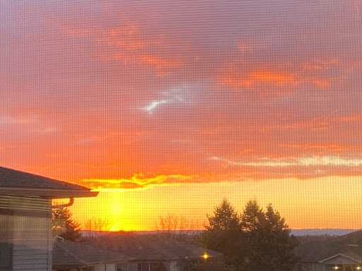 A stunning sunset paints the sky with vibrant hues of orange and purple, creating a serene evening atmosphere.
