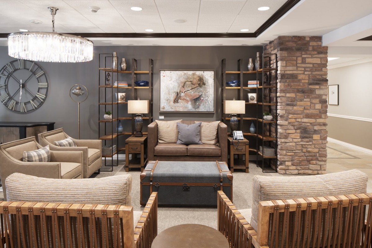 A stylish and modern living room with comfortable seating, decorative shelves, and elegant lighting.