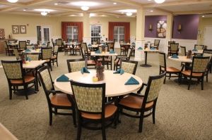 A spacious dining area with neatly arranged tables and chairs, featuring elegant decor and soft lighting.