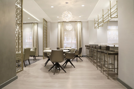 A stylish modern dining area featuring elegant furniture and soft lighting.