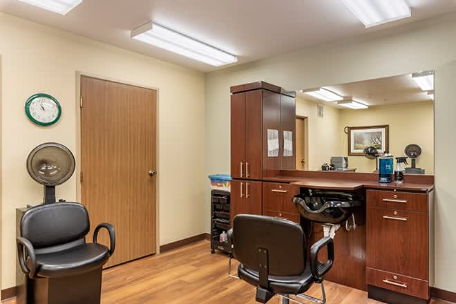 Interior view of a hair salon with chairs and styling stations.