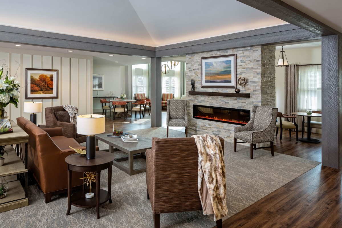 A modern living room featuring a cozy seating area with a fireplace and contemporary furniture.