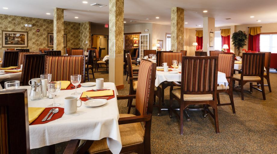 Cozy restaurant dining area with neatly set tables and chairs.