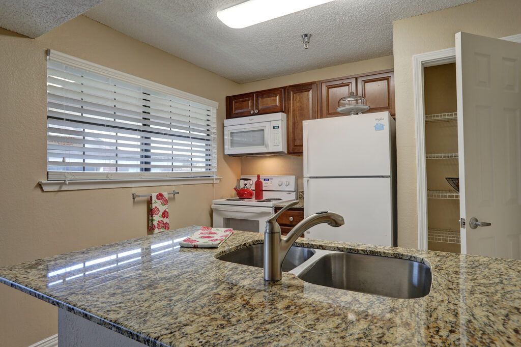 Modern kitchen with granite countertops and standard appliances.