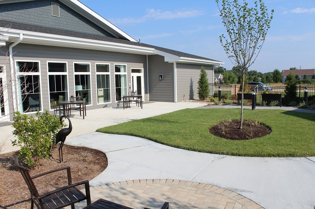 A modern building with a landscaped patio and outdoor seating area.