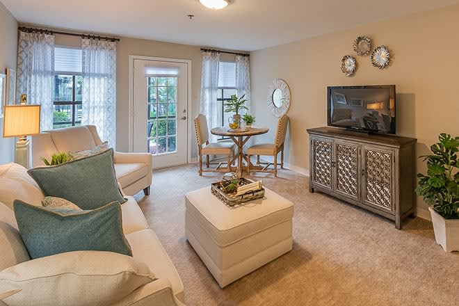 A cozy and stylish living room with modern decor, featuring a comfortable seating area and ample natural light.