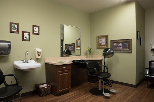 A serene hair salon setup with a mirror, styling chair, and subtle decor.