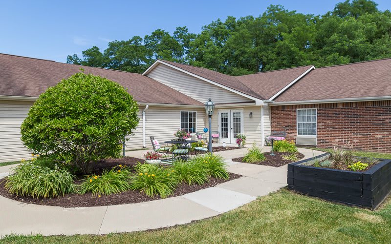 A charming suburban house with a well-maintained garden and outdoor seating area.