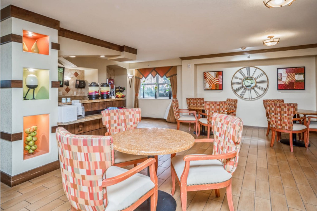 A cozy and well-lit dining area with comfortable seating and decorative accents.